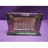 A silver fronted perpetual desk calendar having moulded decoration to rim, Birmingham 1924, makers