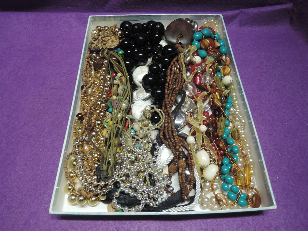 A selection of costume jewellery necklaces including cord and bead necklaces, coconut shell pendant,
