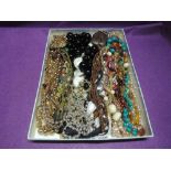 A selection of costume jewellery necklaces including cord and bead necklaces, coconut shell pendant,