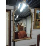 A bevel edged mirror with gilt plaster effect frame