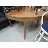 A vintage teak circular dining table