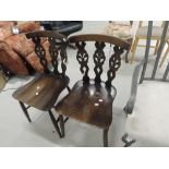 A pair of Ercol dark stained dining chairs