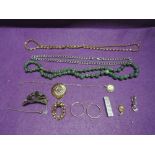 A selection of costume jewellery including an HM silver ingot, white metal Mexican hair comb, HM