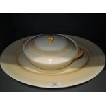 A yellow glaze charger plate and tureen by Wedgwood