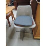 A vintage swivel plastic chair