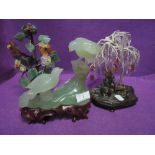 A selection of Chinese hand carved statues or figures including large jade birds of paradise and