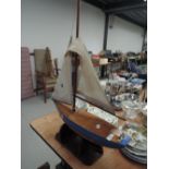 A hand made sailing boat or yacht with stand