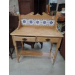 A stripped pine and tileback washstand