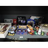 A selection of toys and curios including cast money bank die cast cars and sew on patches