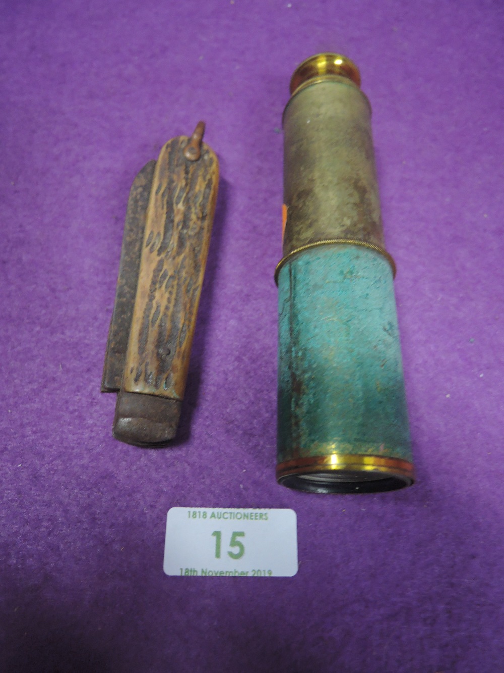 A large horn handle pocket knife and brass scope