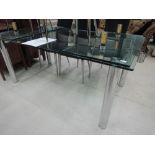 A glass and chrome extending dining table, retail £2800