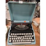 A teal blue portable typwriter