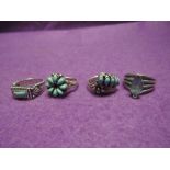Four white metal dress rings stamped 925, all having turquoise style decoration