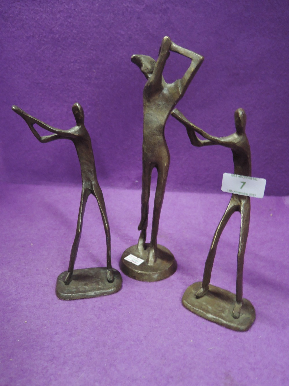 A set of three bronze golf figures or sculptures un signed