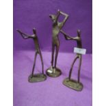 A set of three bronze golf figures or sculptures un signed