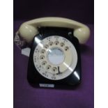 A mid century black and white two tone plastic telephone
