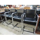 A set of four vintage style chrome and leatherette bar stools
