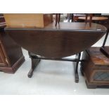 A vintage oak drop leaf refectory style table
