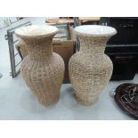 A pair of wicker bound vases