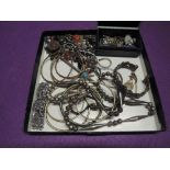 A selection of white metal and other costume jewellery including necklaces, bangles, earrings, and