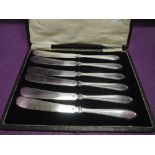 A cased set of Victorian silver plated butter knives of plain moulded form by Roberts and Belk