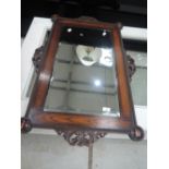 An early 20th Century oak wall mirror