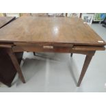 A vintage drawer leaf dining table