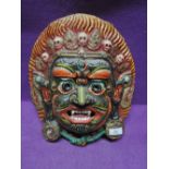A hand painted face mask possibly from Bali or Sri Lanka