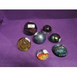 A selection of glass paper weights including Caithness Pilgramage