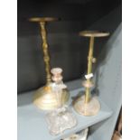 A selection of brass stands and plated candle stick