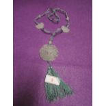 A jade pendant and beaded necklace with moth or butterfly decoration