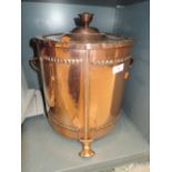 A lidded copper coal bucket