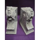 A pair of cast wall brackets or corbel with gargoyle faces