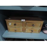 A stripped pine small chest of four drawers