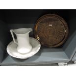 A large hand worked brass tray and wash jug and bowl set