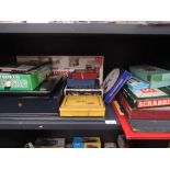 A shelf of vintage board games including Touring Scotland, Millionaire, Chase, Royale etc, all