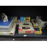 A shelf of Corgi (china) EFE and Matchbox Models of Yesteryear diecasts including Buses, Adverting