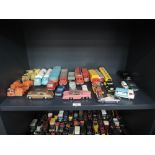 A shelf of Dinky, Corgi, Matchbox, and similar diecasts including Milk Tankers, Chipperfield Circus,