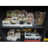 Two shelves of KH Norton, Lledo and similar diecast advertising vehicles all boxed or cased