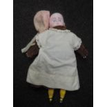 An early 20th century wax headed doll having fixed open eyes, wax limps and cloth body