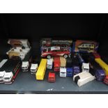 Two shelves of mixed playworn diecasts including Corgi articulated advertising wagons including