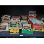 A shelf of Lledo, Rio, Budgie, Matchbox and Dinky diecast buses, all in window display boxes