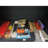 A shelf of mixed gauge engines, rolling stock and accessories including Hornby 00 gauge Power Car