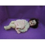 An early 20th century German Simon & Halbig bisque headed doll having sleep eyes, trembling