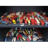 Two shelves of mixed playworn diecast buses including early Lesney, Corgi and Dinky, later Matchbox,