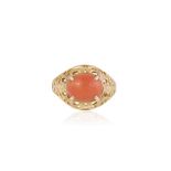 A CORAL AND GOLD RING, the oval coral cabochon set on a pierced mount, mounted in 18K gold, French