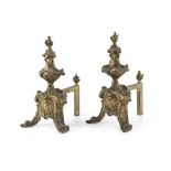 A PAIR OF CAST BRASS FIRE DOGS, the flame finials raised above leaf and scroll baluster columns on