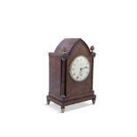 AN EARLY 19TH CENTURY MAHOGANY CASED MANTLE CLOCK, by J King, London, the arched top with acorn