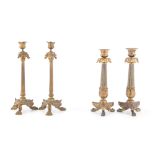 A PAIR OF FRENCH GILT BRONZE FLUTED CANDLESTICKS, with leaf cast decoration, together with another