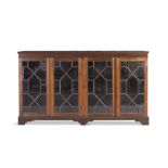 A MAHOGANY LONG RECTANGULAR LOW BOOKCASE, with moulded top above astragal glazed panel doors, on